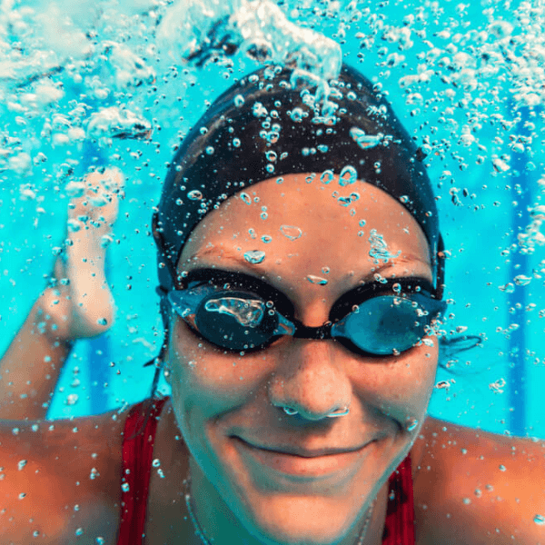 Woman swimming with goggles to avoid using contact lenses in pool