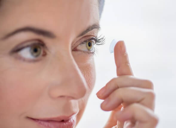 Woman putting contact lenses to check if they hurt